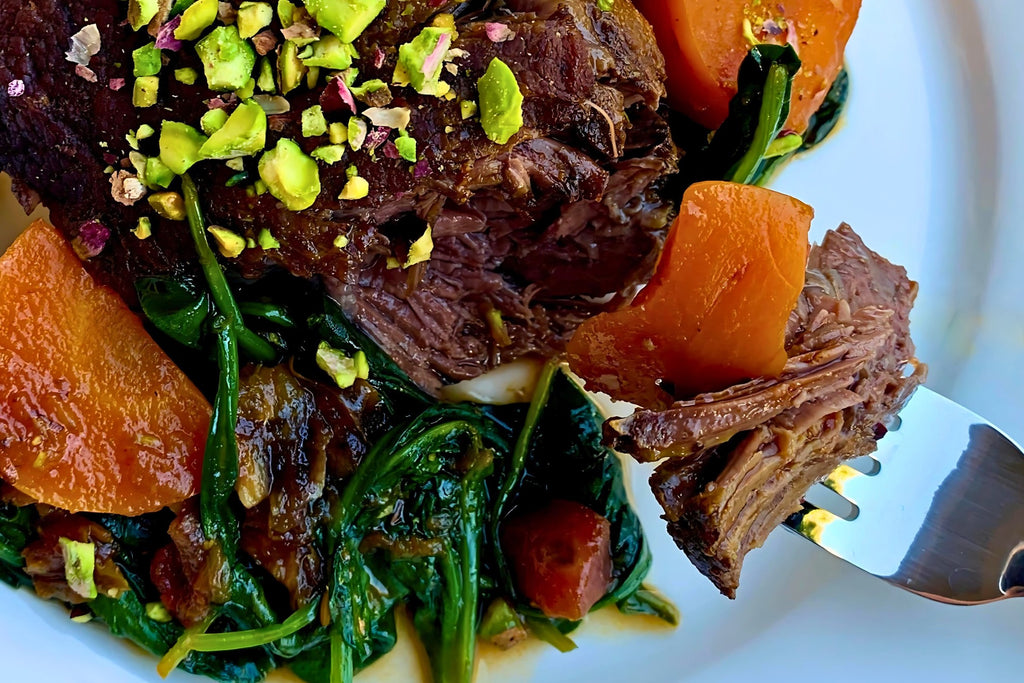 Braised beef cheeks with carrots and spinach are a one-pot meal made perfect with preserved lemon.