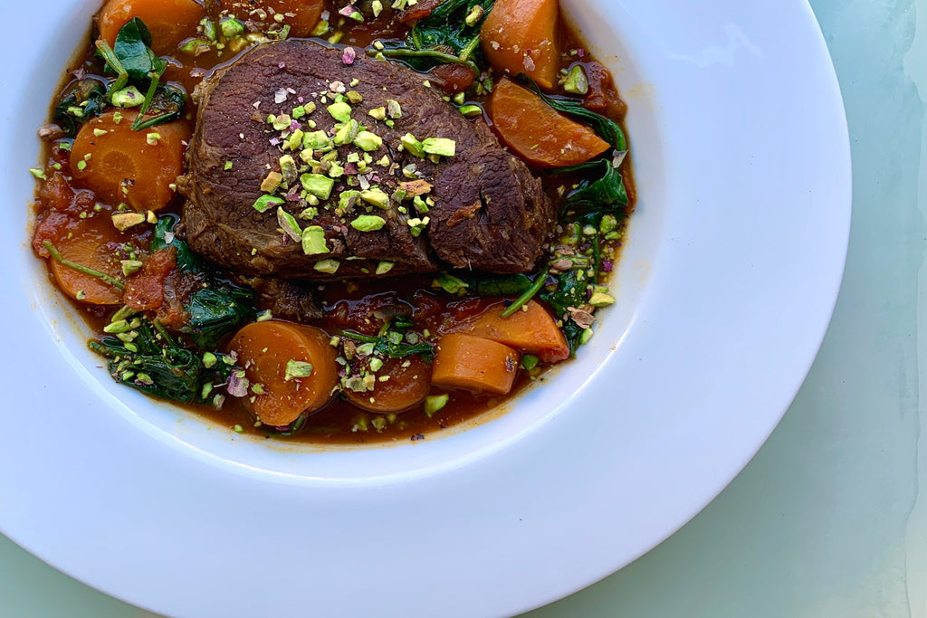 Braised beef cheeks with carrots and spinach are a one-pot meal made perfect with preserved lemon.